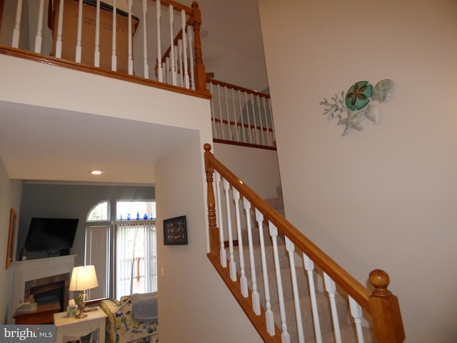 stairs with a glass covered fireplace