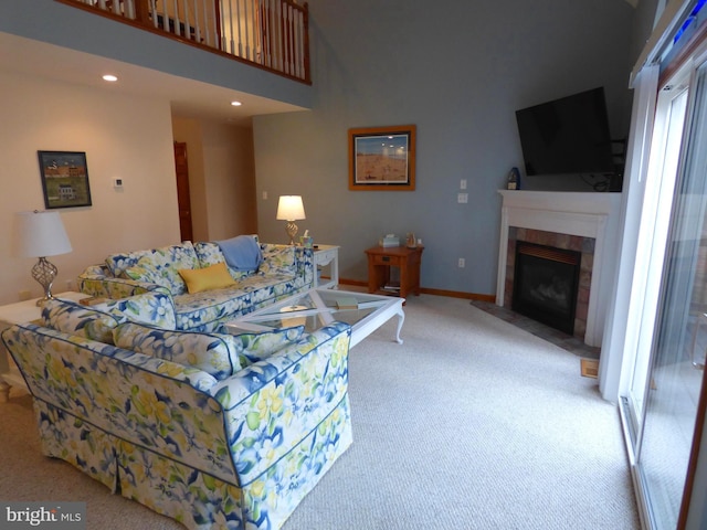living area featuring light colored carpet, baseboards, a tile fireplace, and recessed lighting