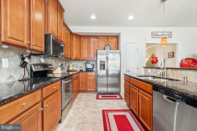 kitchen featuring a sink, stainless steel appliances, and brown cabinetry