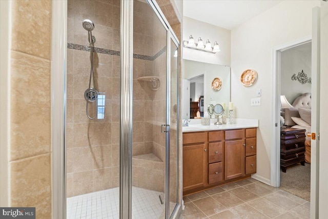 bathroom featuring ensuite bathroom, vanity, tile patterned floors, and a shower stall