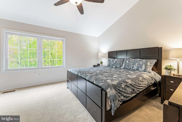 bedroom featuring lofted ceiling, visible vents, multiple windows, and light colored carpet