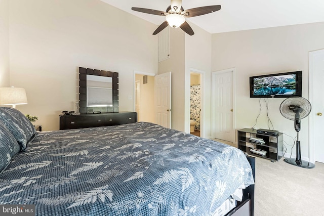carpeted bedroom with high vaulted ceiling, ceiling fan, and baseboards
