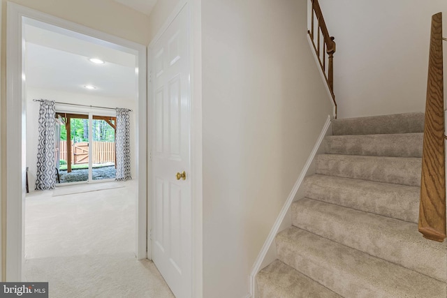 stairs with baseboards, recessed lighting, and carpet flooring