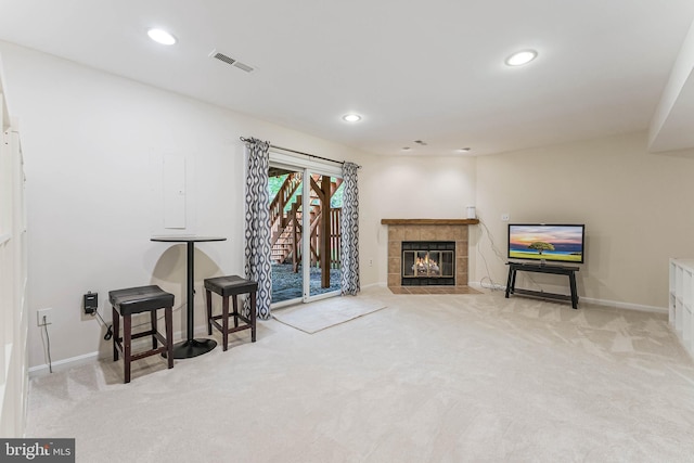 living room with a tiled fireplace, recessed lighting, carpet floors, baseboards, and visible vents