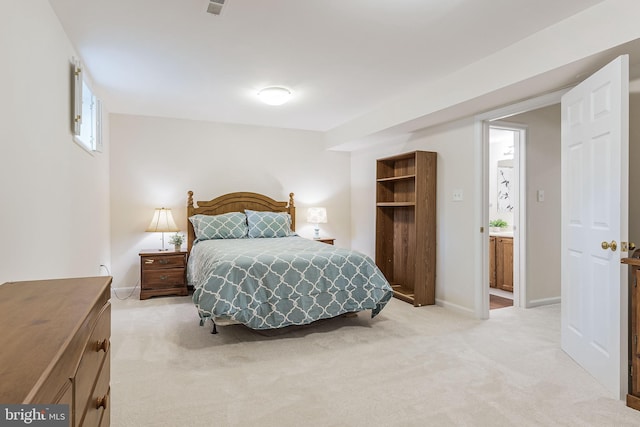 bedroom featuring light colored carpet and baseboards