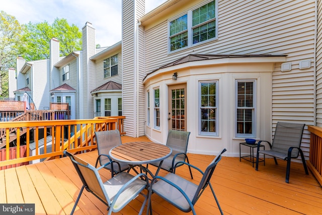 wooden terrace featuring outdoor dining area