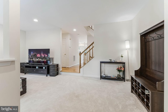 carpeted living room with recessed lighting, stairway, and baseboards