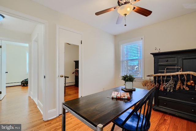 bedroom with light wood-style floors and a baseboard heating unit