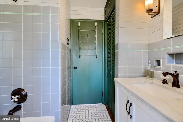 bathroom with tile walls and vanity