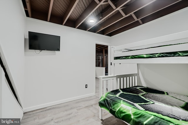 bedroom featuring baseboards and light wood finished floors