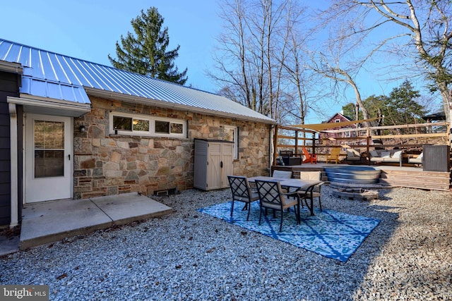 view of patio / terrace with a deck and outdoor dining area