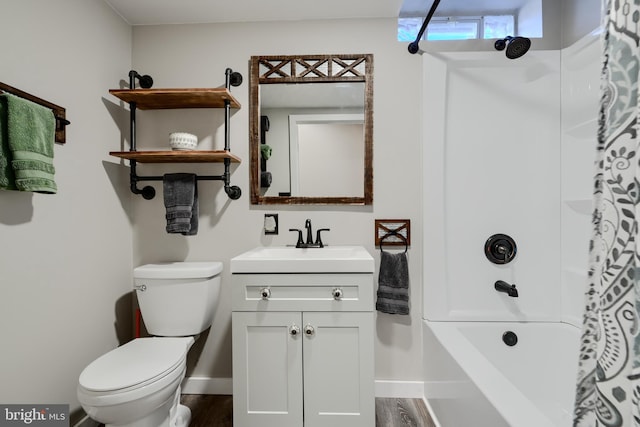 bathroom featuring toilet, wood finished floors, vanity, and baseboards