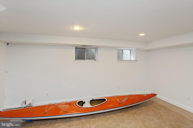 below grade area with baseboards and recessed lighting