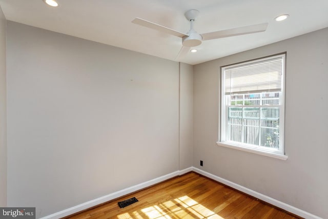 unfurnished room featuring visible vents, baseboards, recessed lighting, wood finished floors, and a ceiling fan