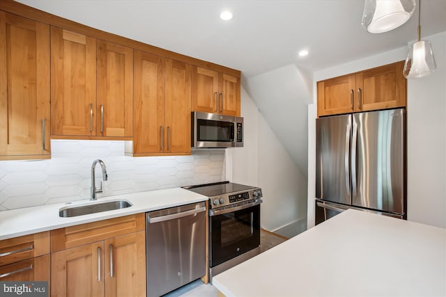 2858 S Abingdon St, Arlington, VA 22206 - kitchen with appliances with stainless steel finishes, a sink, light countertops, brown cabinets, and tasteful backsplash
