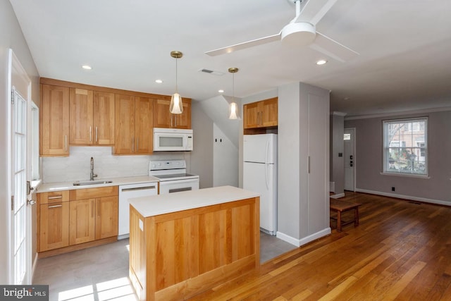 kitchen featuring a sink, ceiling fan, light countertops, white appliances, and backsplash