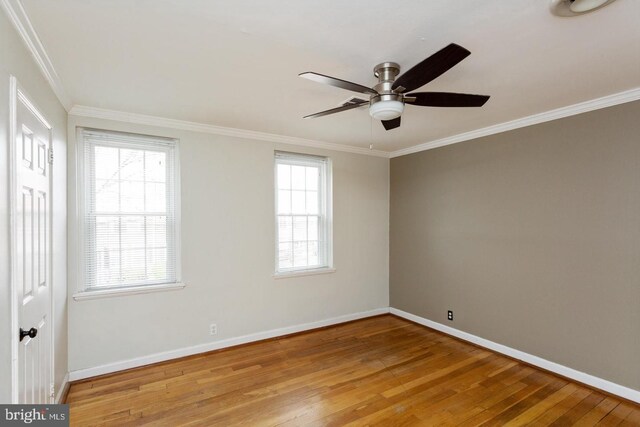 spare room featuring crown molding, a ceiling fan, hardwood / wood-style floors, and baseboards