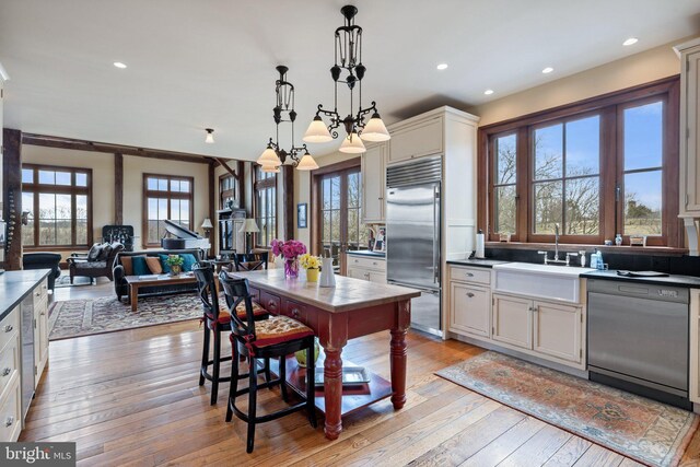 9425 Blackpond Ln, Delaplane, VA 20144 - kitchen featuring stainless steel built in refrigerator, dishwasher, a sink, light wood-style flooring, and pendant lighting