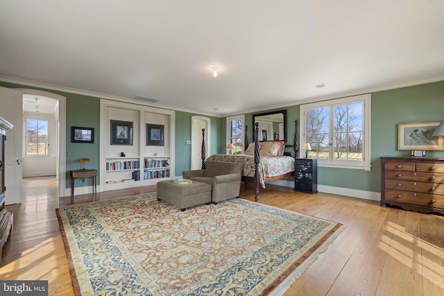 9425 Blackpond Ln, Delaplane, VA 20144 - living room featuring ornamental molding, arched walkways, baseboards, and light wood finished floors