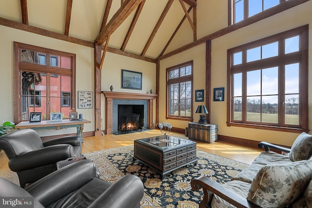 9425 Blackpond Ln, Delaplane, VA 20144 - living area featuring high vaulted ceiling, baseboards, a fireplace with flush hearth, wood finished floors, and beam ceiling