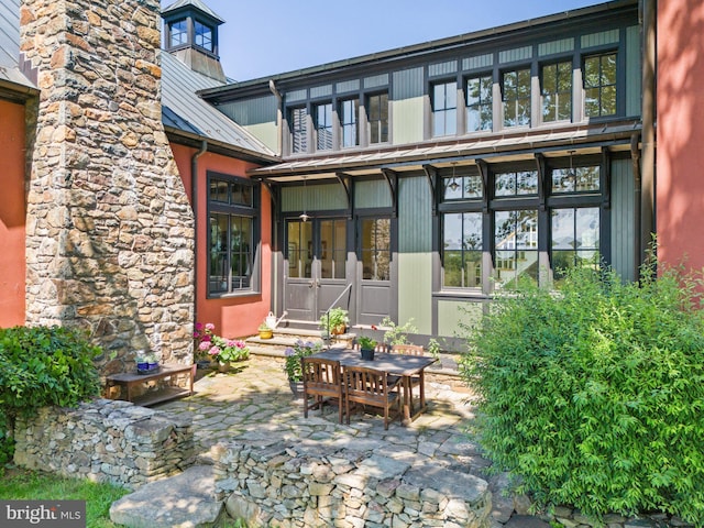 9425 Blackpond Ln, Delaplane, VA 20144 - back of property featuring metal roof, a patio area, a standing seam roof, a chimney, and entry steps