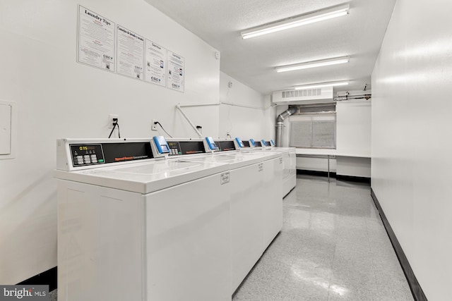 5500 Friendship Blvd Unit 2308N, Chevy Chase, MD 20815 - community laundry room with washing machine and dryer, granite tiled floors, and a textured ceiling