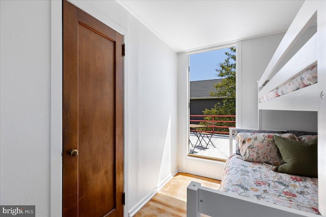 bedroom featuring baseboards and light wood-type flooring