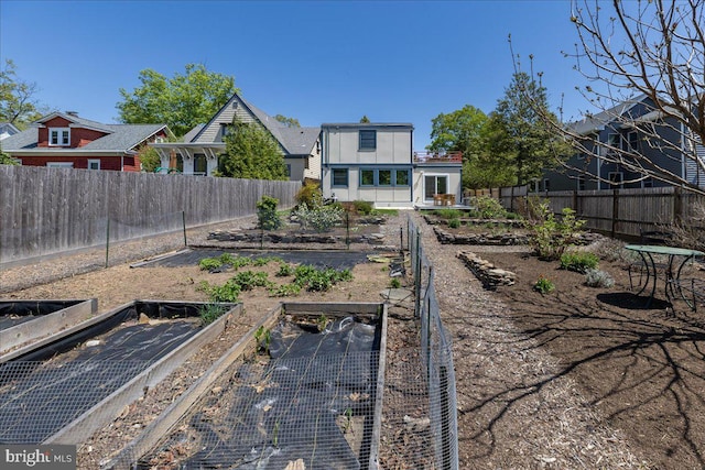 view of yard with a fenced backyard and a vegetable garden