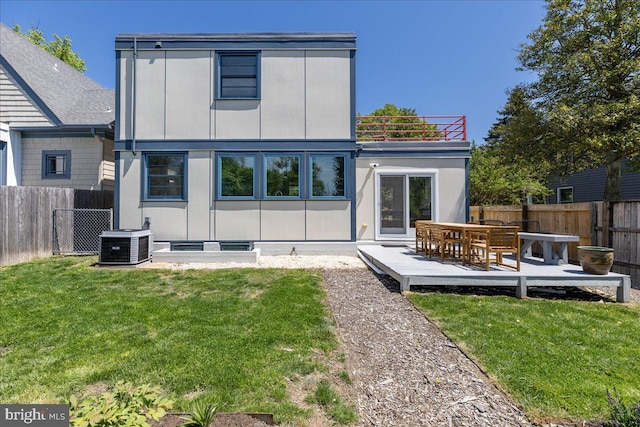 rear view of property with a fenced backyard, central AC, a yard, and a wooden deck