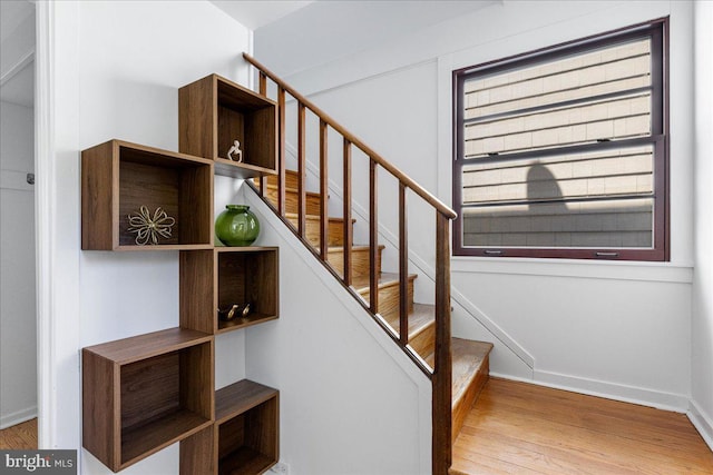 stairway featuring baseboards and wood finished floors