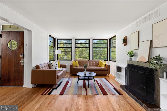 living area with wood finished floors and visible vents