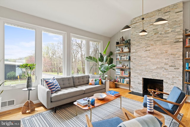 4600 Blagden Ter NW, Washington, DC 20011 - living room featuring vaulted ceiling, wood finished floors, a fireplace, and baseboards