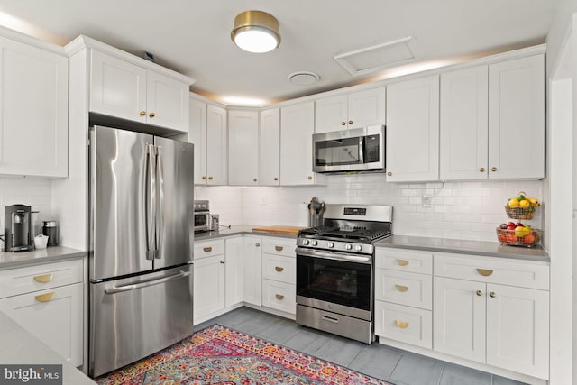4600 Blagden Ter NW, Washington, DC 20011 - kitchen featuring stainless steel appliances, white cabinets, decorative backsplash, and light countertops