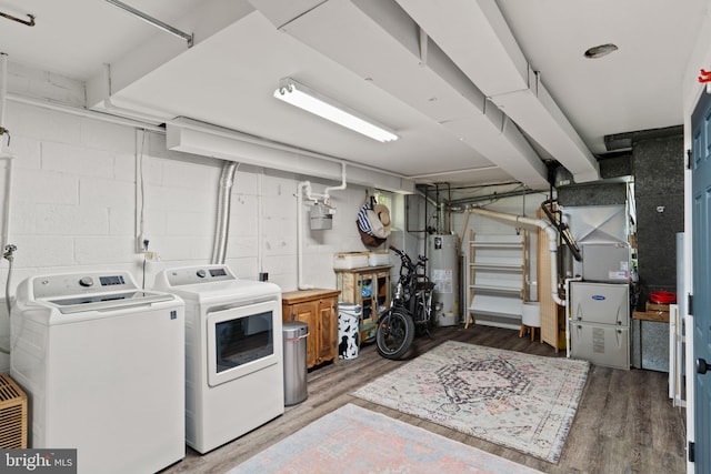 4600 Blagden Ter NW, Washington, DC 20011 - washroom with separate washer and dryer, gas water heater, light wood finished floors, and concrete block wall