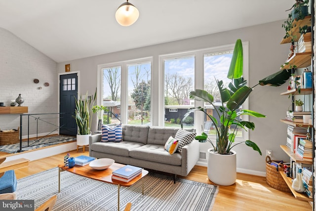 4600 Blagden Ter NW, Washington, DC 20011 - living room featuring wood finished floors, lofted ceiling, and brick wall