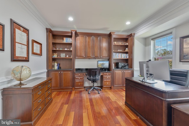 home office with light wood finished floors, built in study area, ornamental molding, and recessed lighting
