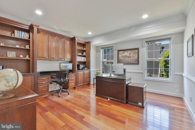 office space featuring baseboards, built in desk, light wood-type flooring, crown molding, and recessed lighting