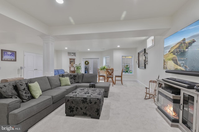 living area featuring baseboards, recessed lighting, visible vents, decorative columns, and light colored carpet