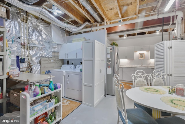 unfinished below grade area featuring independent washer and dryer and stainless steel fridge with ice dispenser