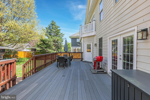 wooden deck featuring fence and outdoor dining area