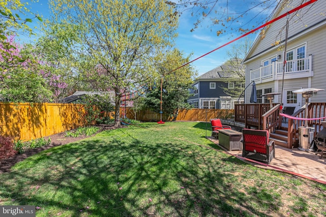 view of yard featuring a patio area, a fenced backyard, and a fire pit