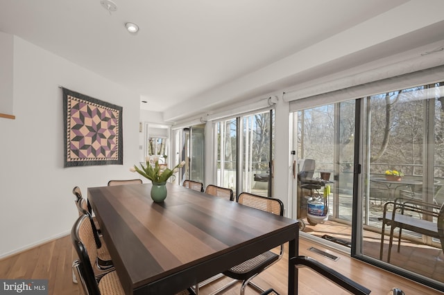 dining space with recessed lighting, wood finished floors, and visible vents