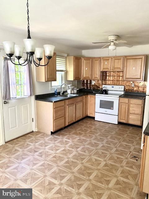 136 Charles Pl, Indian Head, MD 20640 - kitchen featuring white range with electric cooktop, a ceiling fan, a sink, and a healthy amount of sunlight