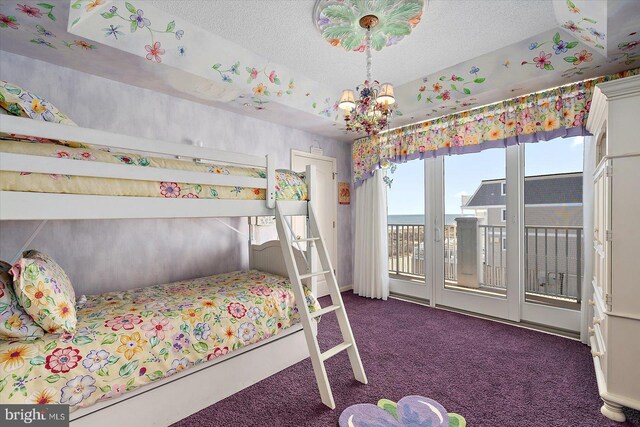 12201 Wight St Unit 301, Ocean City, MD 21842 - bedroom with access to exterior, an inviting chandelier, carpet floors, and a textured ceiling