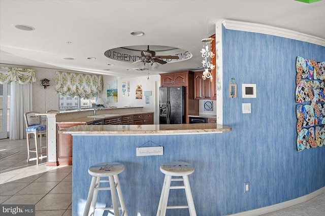12201 Wight St Unit 301, Ocean City, MD 21842 - kitchen featuring a kitchen breakfast bar, ceiling fan, black refrigerator with ice dispenser, and a peninsula