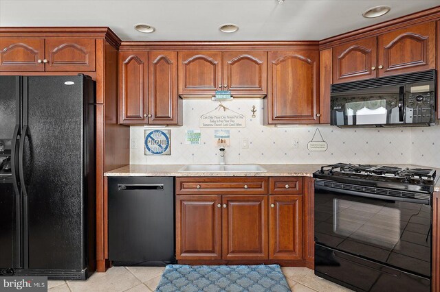 12201 Wight St Unit 301, Ocean City, MD 21842 - kitchen featuring black appliances, light tile patterned flooring, tasteful backsplash, and a sink