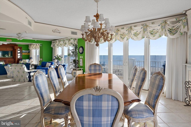 12201 Wight St Unit 301, Ocean City, MD 21842 - dining space featuring light tile patterned floors, a water view, ceiling fan with notable chandelier, visible vents, and a textured ceiling