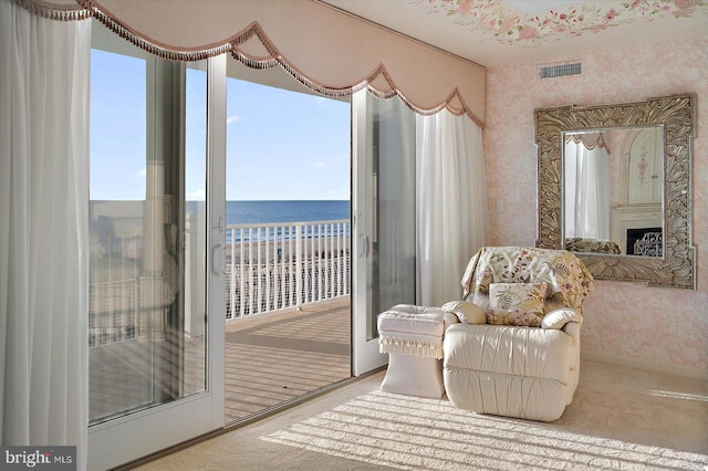 12201 Wight St Unit 301, Ocean City, MD 21842 - sitting room with visible vents, a water view, wallpapered walls, a wealth of natural light, and carpet