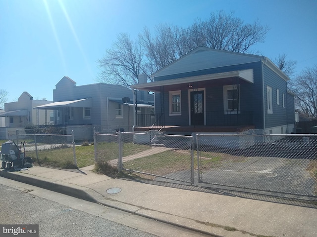 view of front of home featuring a porch, a gate, and a fenced front yard