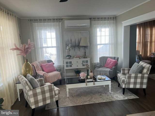 living area with ornamental molding, an AC wall unit, and wood finished floors